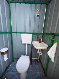 a small bathroom with a toilet and a sink at Green Oasis Retreat in Bar