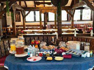 a table with a blue table cloth with food on it at Hotel Main Taunus in Hochheim am Main