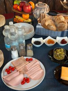 a table topped with plates of meat and other foods at Hotel Main Taunus in Hochheim am Main +31 photos