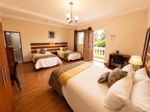 a hotel room with two beds and a window at Casa de Avila Hotel in Arequipa +57 photos