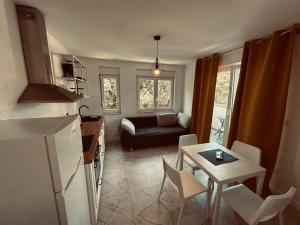 a kitchen and living room with a couch and a table at Marija in Pakoštane