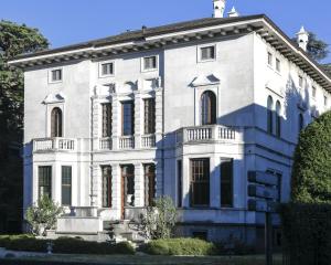 a large white house with a blue at CASABIANCA Suites in Como