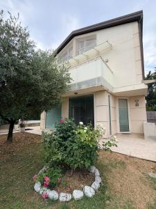 a house with a bush in front of it at Villa Celeste -Flexrent Immobiliare Abissinia in Santa Maria di Scacciano