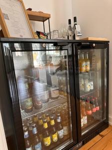 a refrigerator filled with lots of bottles of alcohol at Risinge Herregård Bed & Breakfast in Ullerslev