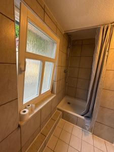 a bathroom with a shower and a tub and a window at Schwarzer Adler in Streitberg +48 photos