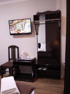 a mirror and a piano in a room at AL-BUKHARI Boutique Hostel in Bukhara