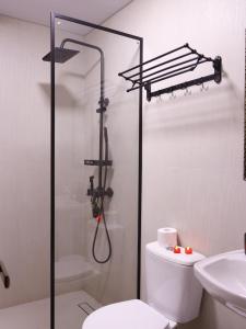 a bathroom with a shower and a toilet and a sink at AL-BUKHARI Boutique Hostel in Bukhara +39 photos