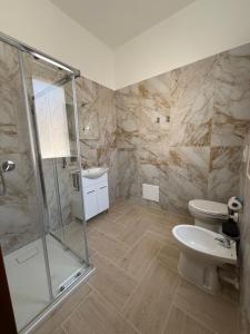 a bathroom with a shower and a toilet and a sink at Holmann Haus in Olbia