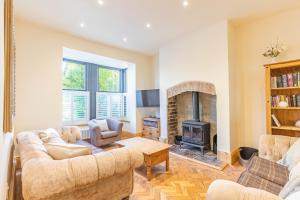 a living room with two couches and a fireplace at Spacious Central Harrogate Retreat in Harrogate