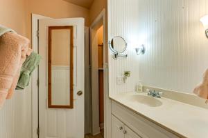 a bathroom with a sink and a mirror at Unplug! Lake Toxaway Cabin w/ Dock Access in Lake Toxaway +18 photos