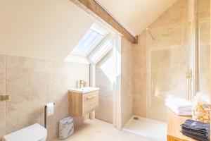 a bathroom with a shower and a toilet and a sink at Spacious Central Harrogate Retreat in Harrogate +20 photos