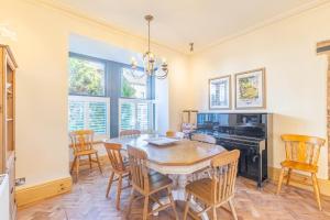a dining room with a table and chairs at Spacious Central Harrogate Retreat in Harrogate