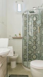 a bathroom with a shower and a toilet and a sink at torre poesia in Trani +11 photos