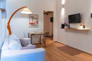 a living room with a white couch and a table at torre poesia in Trani