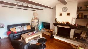 a living room with a couch and a fireplace at Armonia edificio storico del 1563. in Cevio