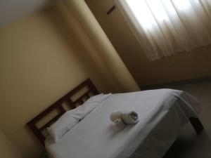 a bedroom with a bed with a stuffed elephant on it at Hospedaje San Valentin in Capitan Concha