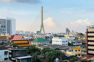 a view of a city with a tower in the background at Mam's House Khaosan in Bangkok