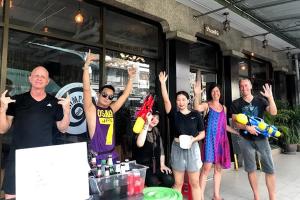 a group of people with their hands in the air at Mam's House Khaosan in Bangkok