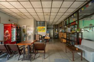 a restaurant with tables and chairs in a room at Mam's House Khaosan in Bangkok