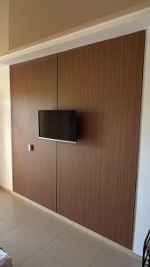 a wooden wall with a flat screen tv on it at Dostar Beach Hotel - Достар Жағажай Қонақүйі in Aktau +28 photos