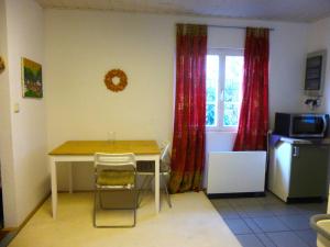 eine Küche mit einem Tisch und Stühlen sowie einem Fenster in der Unterkunft Villa Kükenkamp in Rätzlingen