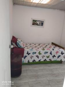 a bedroom with a bed with butterflies on it at Apartamento completo Santa Rosa de Cabal in Santa Rosa de Cabal