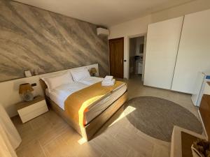 a bedroom with a large bed and a rug at Holmann Haus in Olbia +19 photos