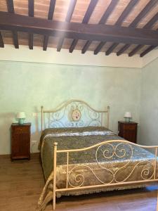 a bedroom with a bed and two night stands at Castello di Acera in Campello sul Clitunno