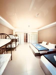 a room with three beds and a room with at Dostar Beach Hotel - Достар Жағажай Қонақүйі in Aktau