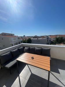 a couch and a table on a roof at Villa Maria III in Vodice