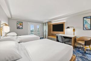 a hotel room with two beds and a desk at Crowne Plaza Orlando-Downtown by IHG in Orlando +135 photos
