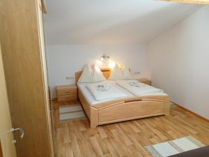 a small bedroom with a bed with a light on it at Stapfgut in Rauris