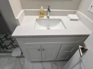 a bathroom sink with a white counter top at Airport room with free parking in Boston +6 photos