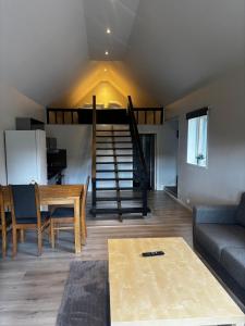 a living room with a couch and a loft at Mysigt litet hus in Näsum