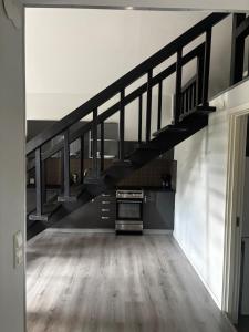 an empty living room with a staircase in a house at Mysigt litet hus in Näsum