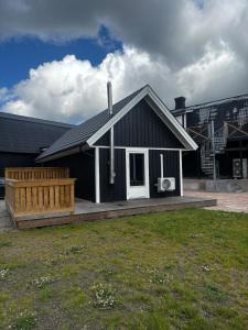 a black and white house with a porch at Mysigt litet hus in Näsum