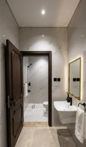 a bathroom with a sink and a toilet and a shower at OrbitNet - Anwarat in Medina +22 photos