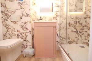 a bathroom with a toilet and a sink and a shower at Attractive barn conversion near Padstow in Saint Merryn +10 photos