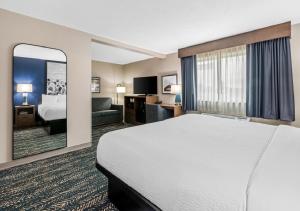 a hotel room with a bed and a large window at Super 8 by Wyndham Perham in Perham