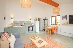 a living room with a blue couch and a table at Attractive barn conversion near Padstow in Saint Merryn