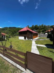 a wooden fence in front of a house at Apartmani LUX in Kolašin +42 photos