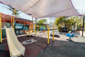 a playground with a slide and a slidesktop at Jacaranda Holiday Park in North Haven