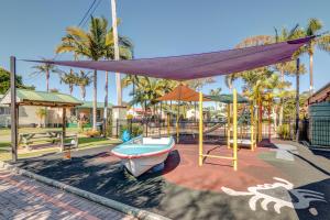 a playground with a boat and a swing at Jacaranda Holiday Park in North Haven