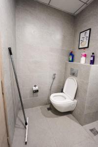a bathroom with a white toilet in a room at Sunbliss Corner in Greater Noida