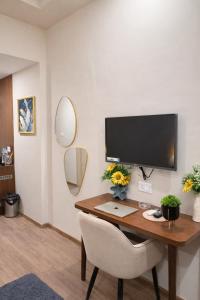 a desk with a computer monitor and a chair at Sunbliss Corner in Greater Noida +5 photos