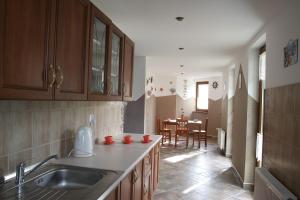 a kitchen with a sink and a dining room at Kapitan Hook in Mielno