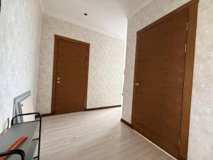 an empty room with two doors and a chair at Novel apartment in Korumdy +10 photos