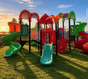 a playground with a slide in the grass at Novel apartment in Korumdy
