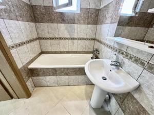 a bathroom with a sink and a bath tub at Anit Rooms in Luštica +4 photos