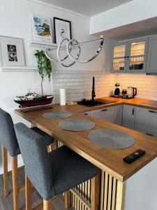 a kitchen with a wooden table and chairs at Puffin rock in Vestmannaeyjar +5 photos